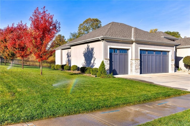 view of side of home with a garage and a lawn