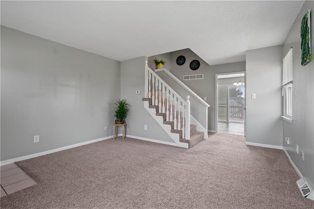 interior space featuring carpet flooring and a chandelier