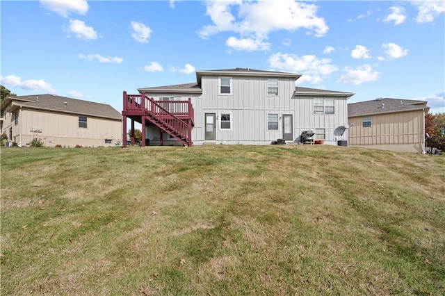 rear view of property with a deck and a yard