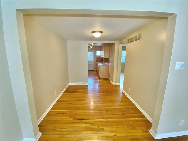 hallway with light hardwood / wood-style flooring