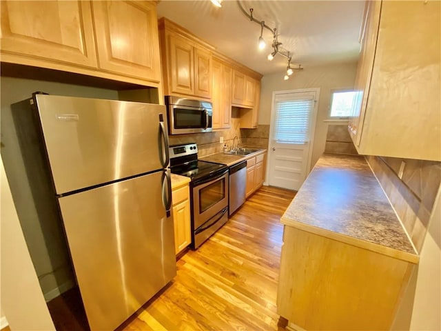 kitchen featuring light hardwood / wood-style floors, light brown cabinets, and stainless steel appliances