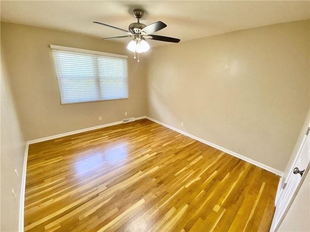 empty room featuring ceiling fan and wood-type flooring