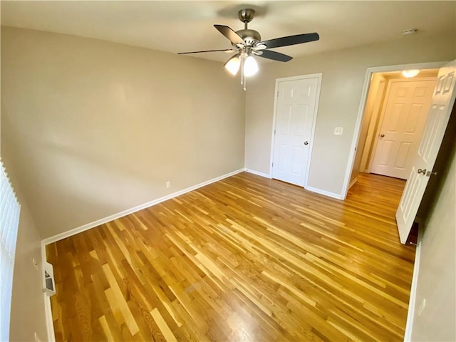 unfurnished bedroom with a closet, light hardwood / wood-style floors, and ceiling fan