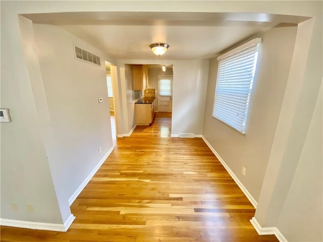 corridor with light hardwood / wood-style flooring