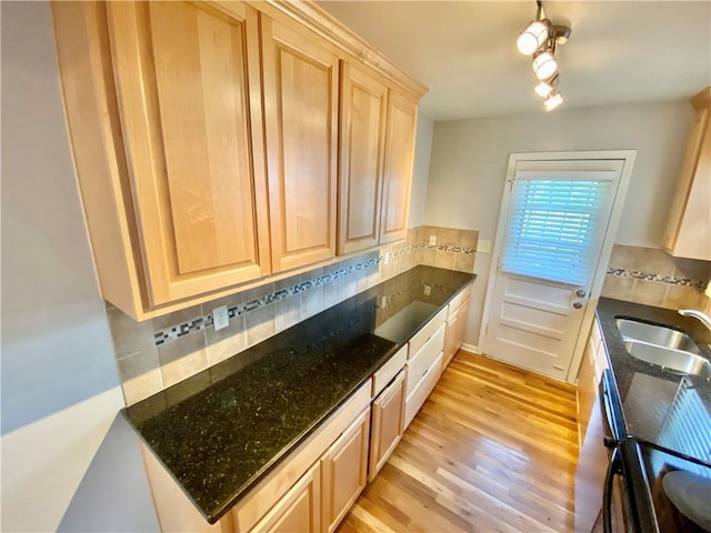 kitchen with tasteful backsplash, light brown cabinetry, and light hardwood / wood-style flooring