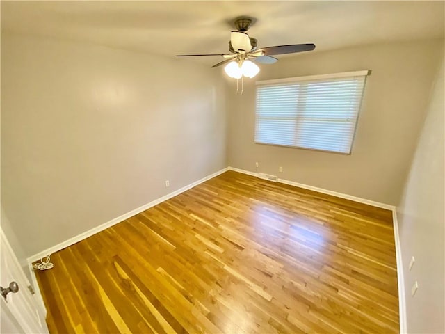 spare room with ceiling fan and wood-type flooring