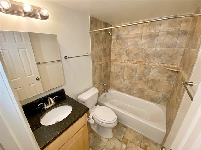 full bathroom featuring vanity, toilet, and tiled shower / bath