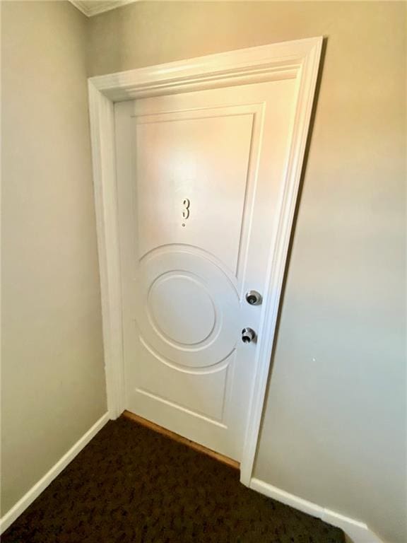 doorway to outside featuring dark carpet