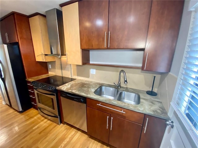 kitchen with extractor fan, light hardwood / wood-style flooring, sink, light stone countertops, and appliances with stainless steel finishes