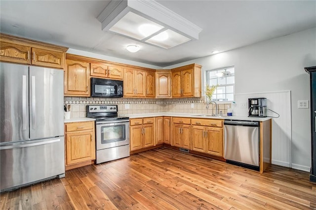 403 S Jackson St, Archie, MO 64725 - kitchen featuring stainless steel appliances, light countertops, wood-type flooring, decorative backsplash, and recessed lighting