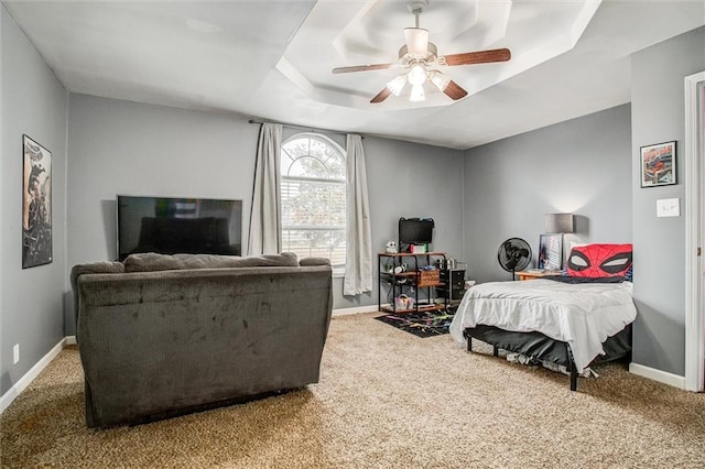 403 S Jackson St, Archie, MO 64725 - carpeted bedroom featuring a tray ceiling and ceiling fan