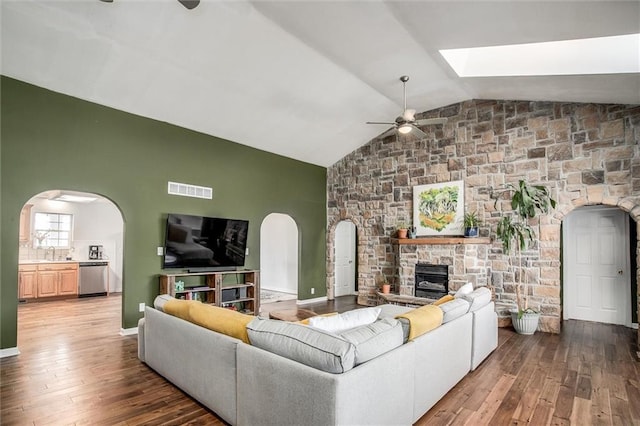 403 S Jackson St, Archie, MO 64725 - living room with ceiling fan, arched walkways, vaulted ceiling, hardwood / wood-style flooring, and a fireplace