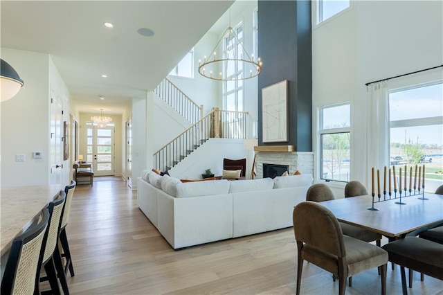 2846 W 133rd Ter, Leawood, KS 66209 - living area featuring a chandelier, healthy amount of natural light, light wood finished floors, a high ceiling, and recessed lighting