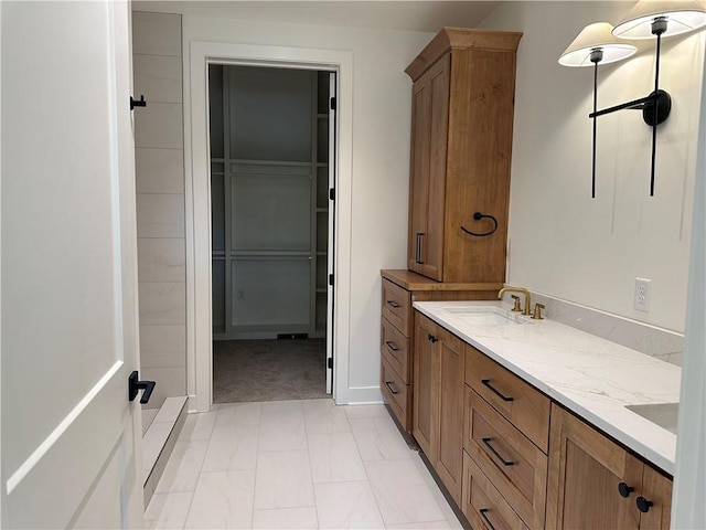 2846 W 133rd Ter, Leawood, KS 66209 - full bath with double vanity, marble finish flooring, and a walk in closet