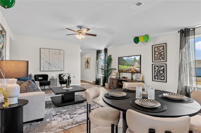 living room with wood-type flooring and ceiling fan