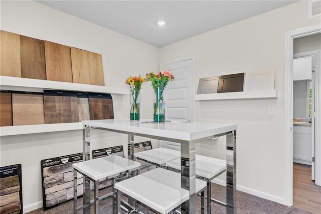 dining space with wood-type flooring