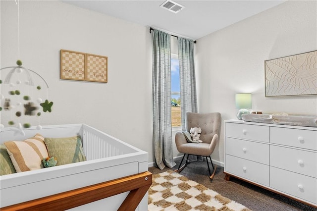 carpeted bedroom with multiple windows and a crib