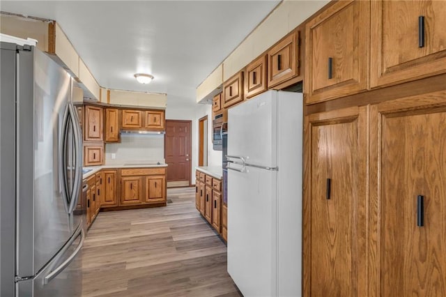 kitchen with stainless steel appliances and light wood-type flooring