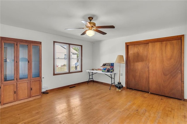 unfurnished bedroom with ceiling fan and light hardwood / wood-style flooring