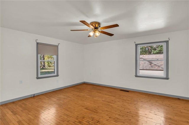 spare room featuring ceiling fan and light hardwood / wood-style flooring