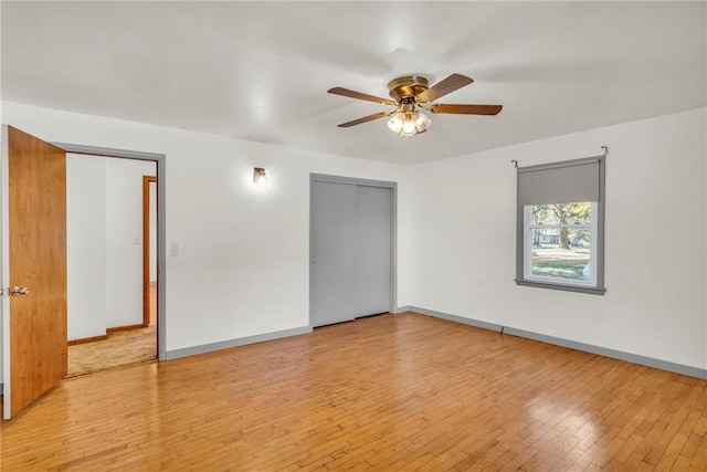 empty room with ceiling fan and light wood-type flooring