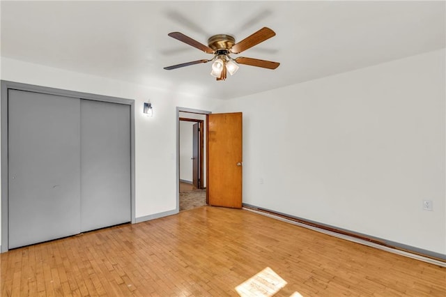 unfurnished bedroom with a closet, ceiling fan, and light hardwood / wood-style flooring