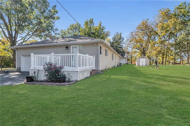 view of home's exterior with a yard, a deck, and a shed