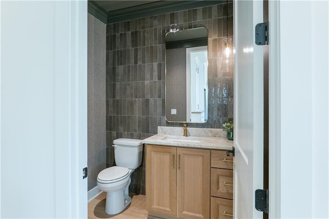 2860 W 133rd Ter, Leawood, KS 66209 - bathroom featuring tile walls, toilet, and vanity