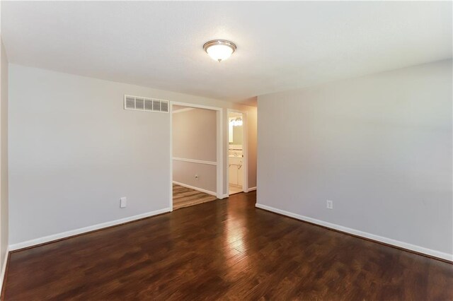 unfurnished room featuring dark hardwood / wood-style flooring