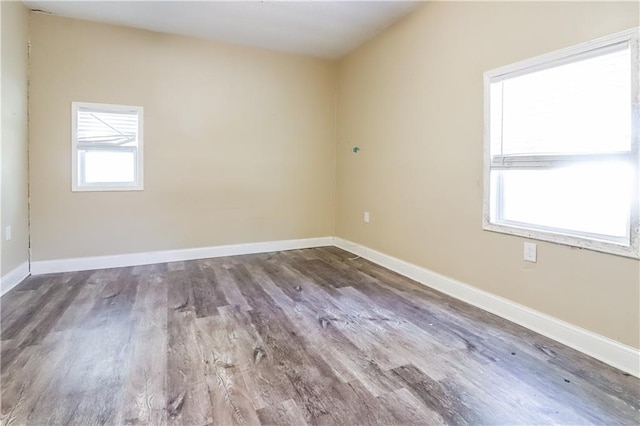 unfurnished room with wood-type flooring