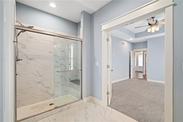 bathroom with ceiling fan and an enclosed shower