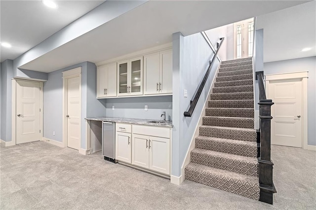 interior space with wet bar and carpet flooring