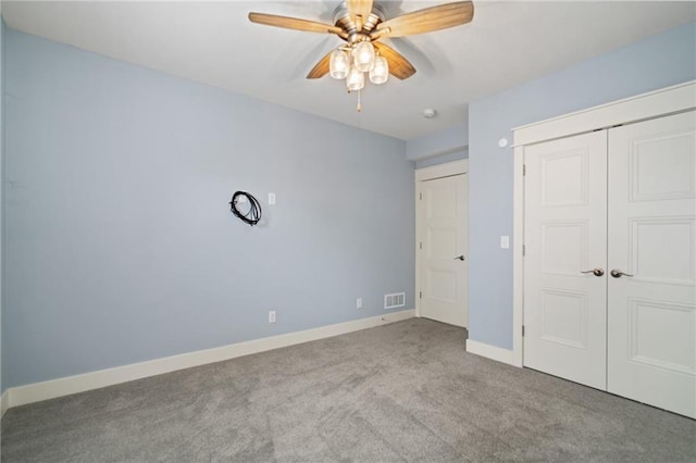 unfurnished bedroom with ceiling fan, a closet, and light colored carpet