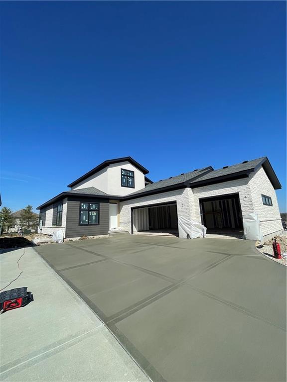 modern farmhouse with a garage and driveway