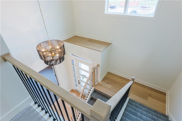 2852 W 133rd Ter, Leawood, KS 66209 - stairs featuring healthy amount of natural light, wood finished floors, and baseboards