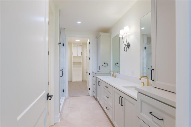 2852 W 133rd Ter, Leawood, KS 66209 - bathroom featuring a shower stall, a walk in closet, double vanity, and recessed lighting