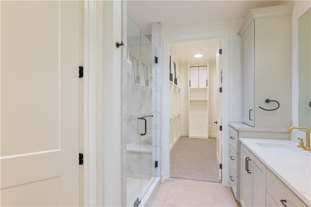 2852 W 133rd Ter, Leawood, KS 66209 - bathroom featuring a stall shower, a walk in closet, vanity, and tile patterned floors