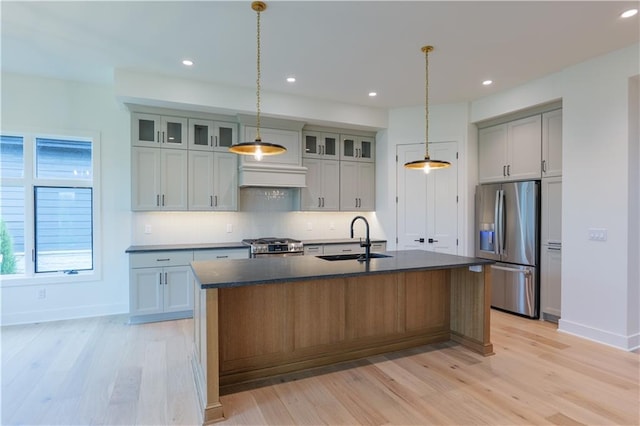 2852 W 133rd Ter, Leawood, KS 66209 - kitchen featuring a sink, stainless steel appliances, dark countertops, light wood-type flooring, and recessed lighting