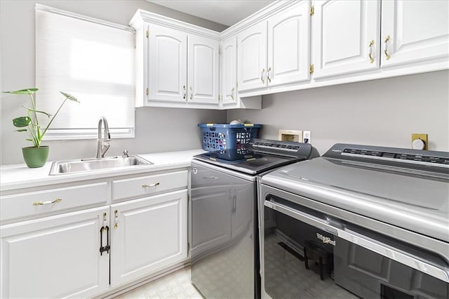 laundry room with washer and dryer, cabinets, and sink