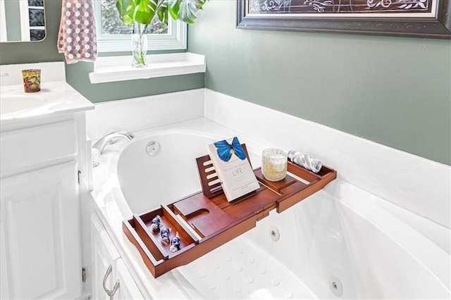 bathroom featuring vanity and a washtub