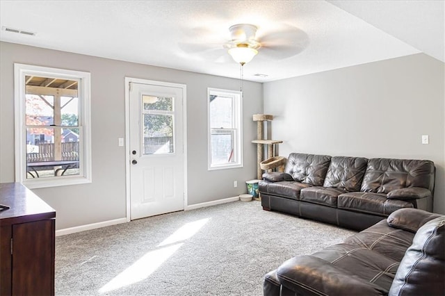 carpeted living room with ceiling fan