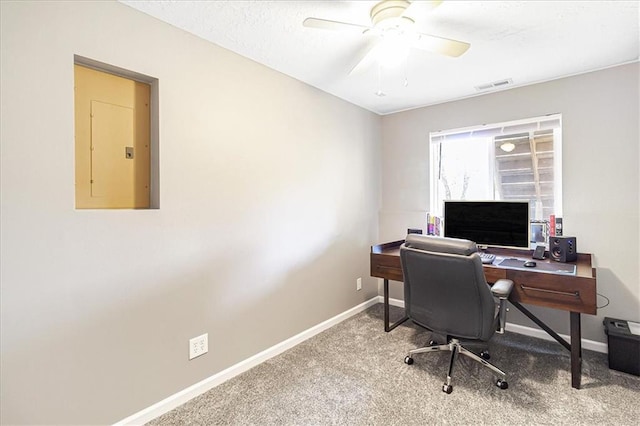 office space with carpet flooring, electric panel, and ceiling fan