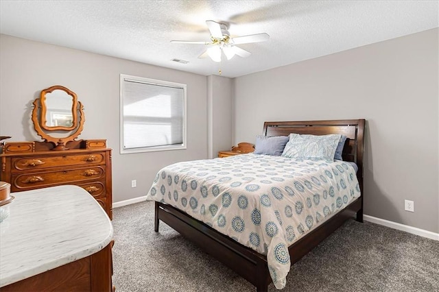 carpeted bedroom with ceiling fan and a textured ceiling