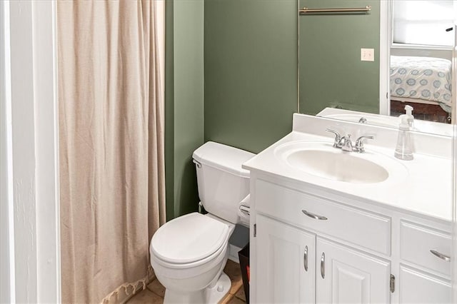 bathroom featuring tile patterned floors, vanity, and toilet