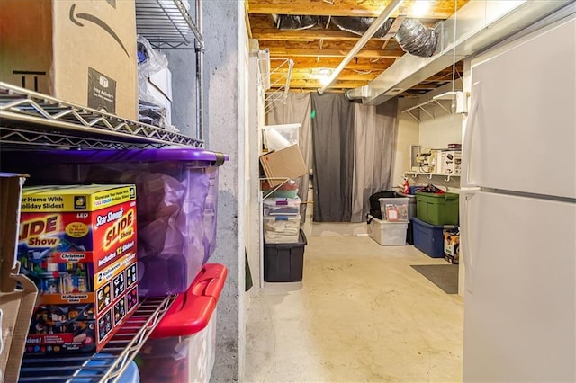 basement featuring white refrigerator