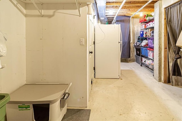 basement with white fridge