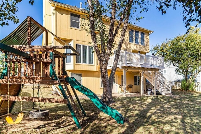 back of house with a patio and a playground