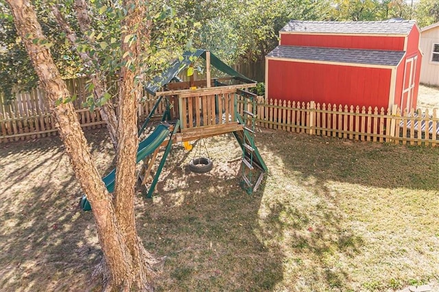 view of jungle gym featuring a storage unit and a lawn