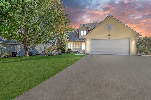 view of front of property with a lawn and a garage