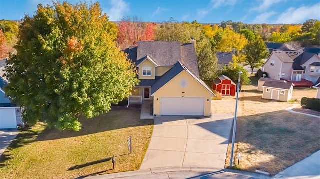 view of front of property with a garage and a storage unit